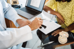 A dentist reviews financial options with a patient.